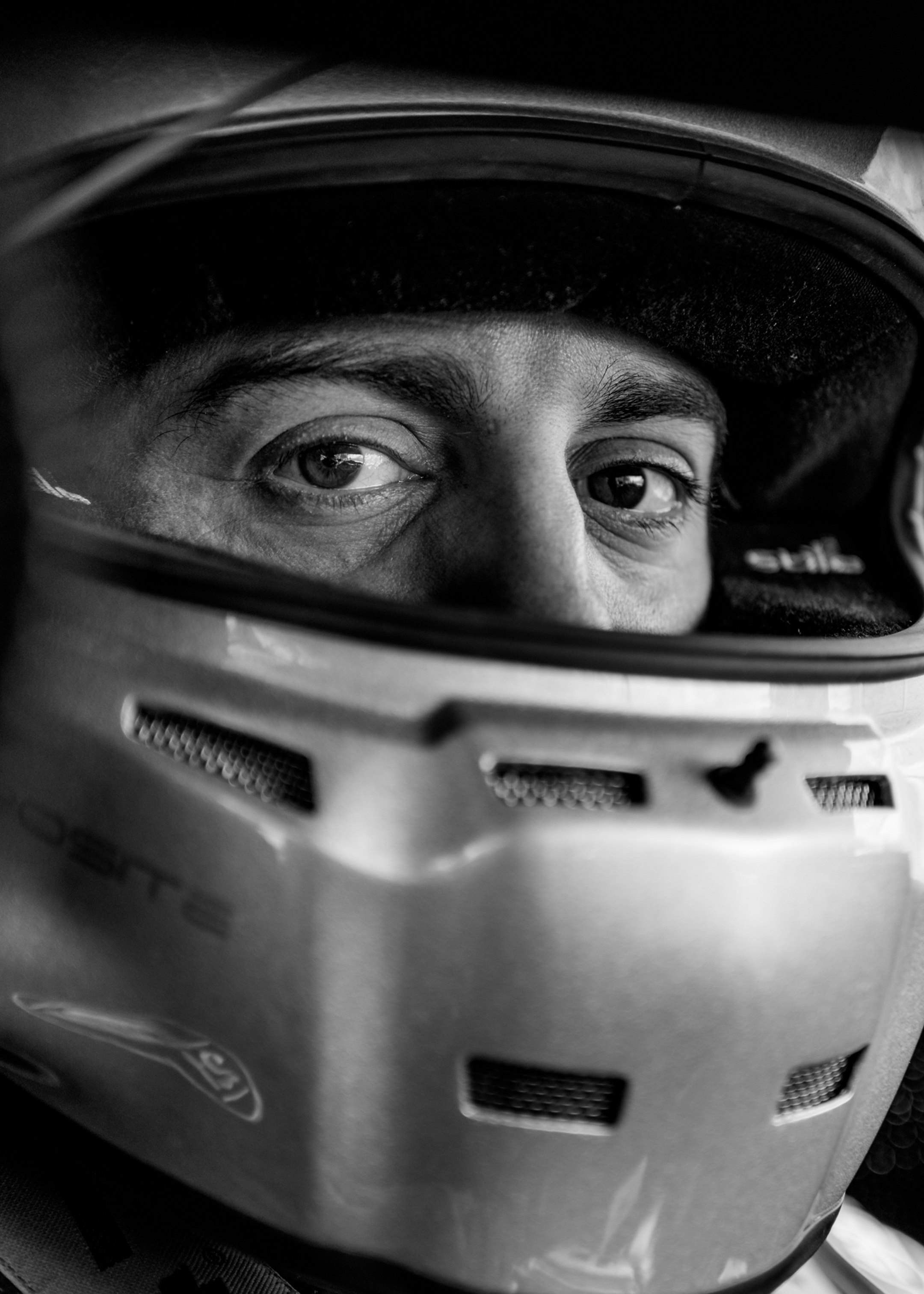 Close-up of a racing drivers eyes through a helmet.