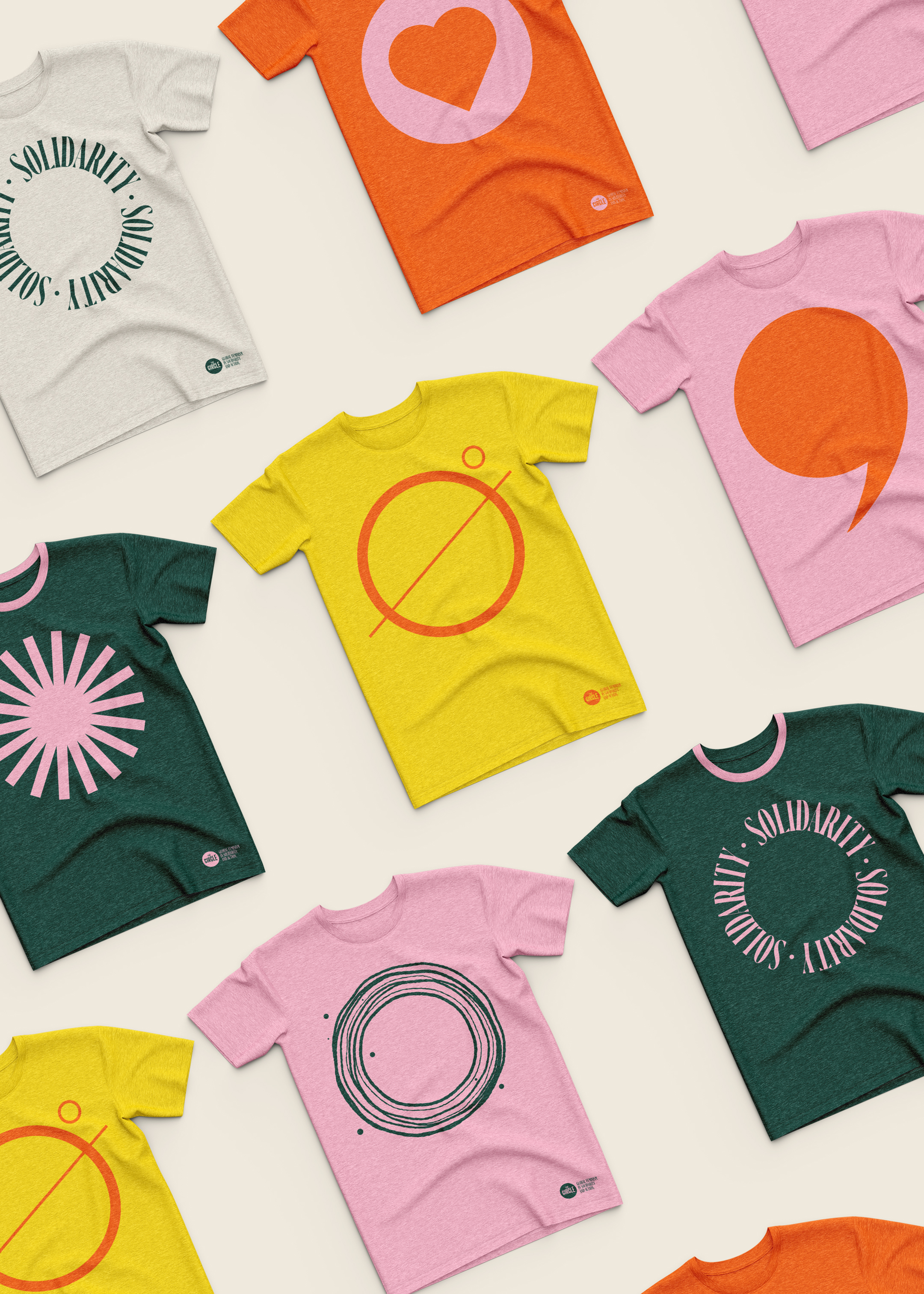 A selection of brightly-coloured branded t-shirts with different artistic variations of a circle.