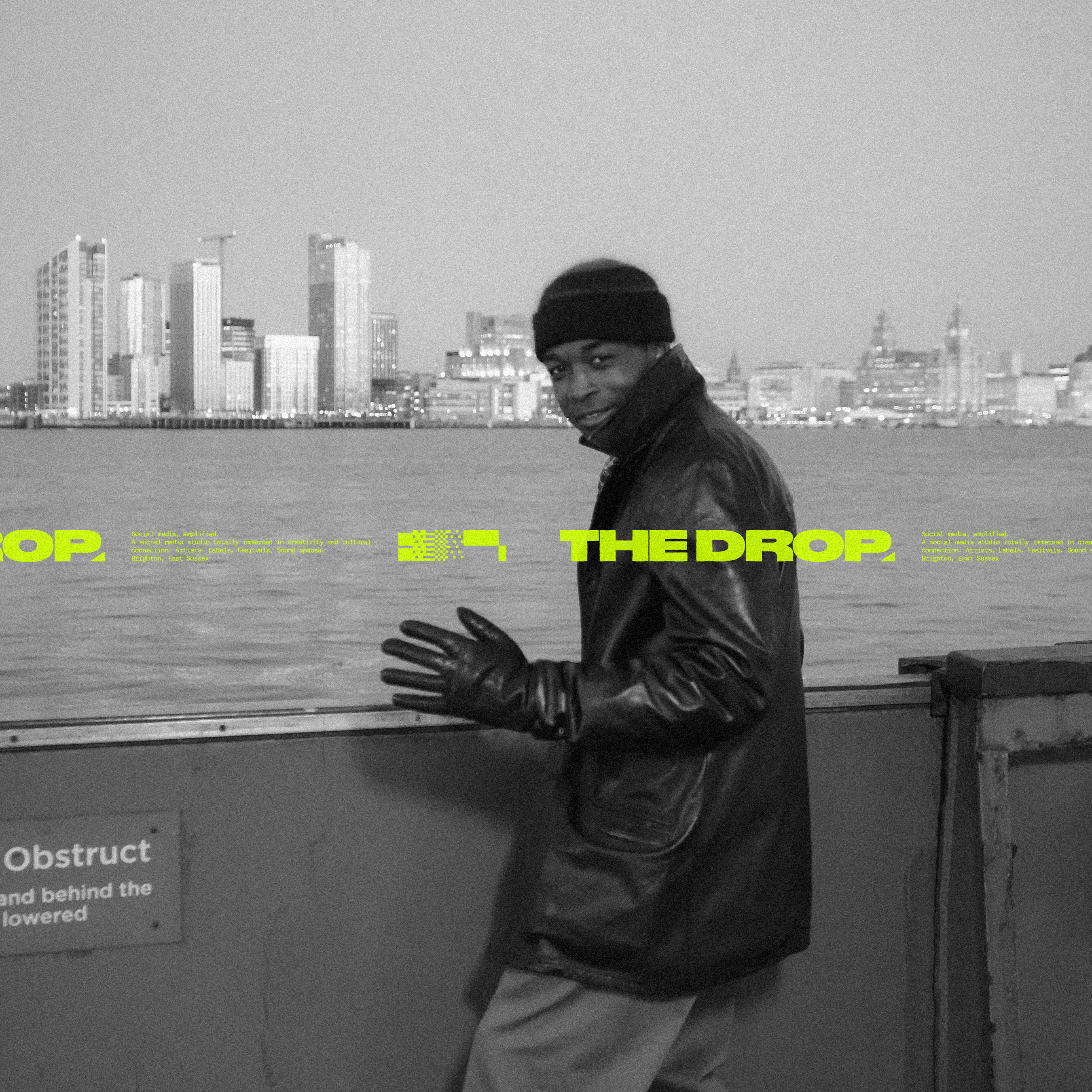 Ticket tape overlaid onto a black and white image of a black man standing on the edge of a river