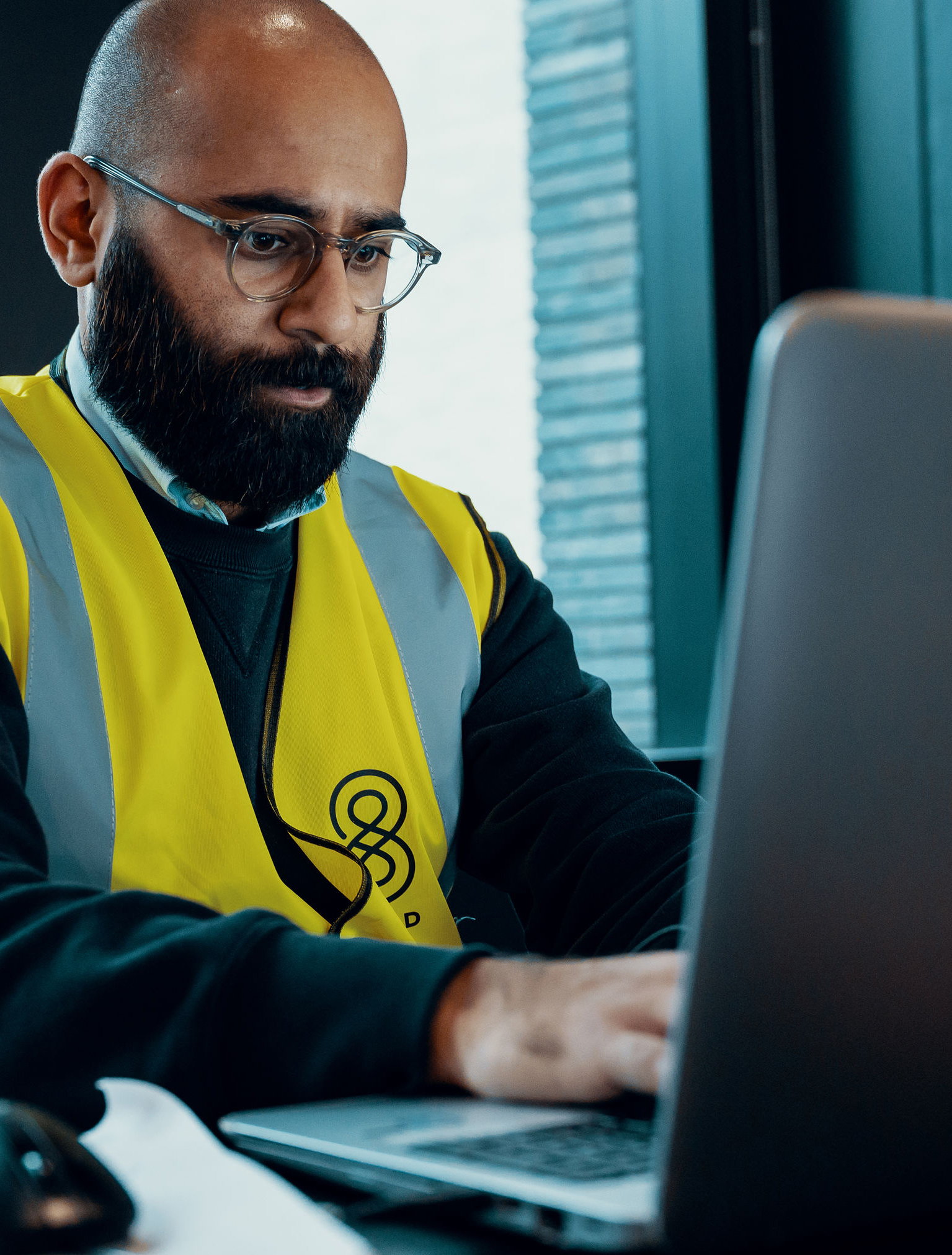 Black jacket with a 8build logo on the left breast, and red trim