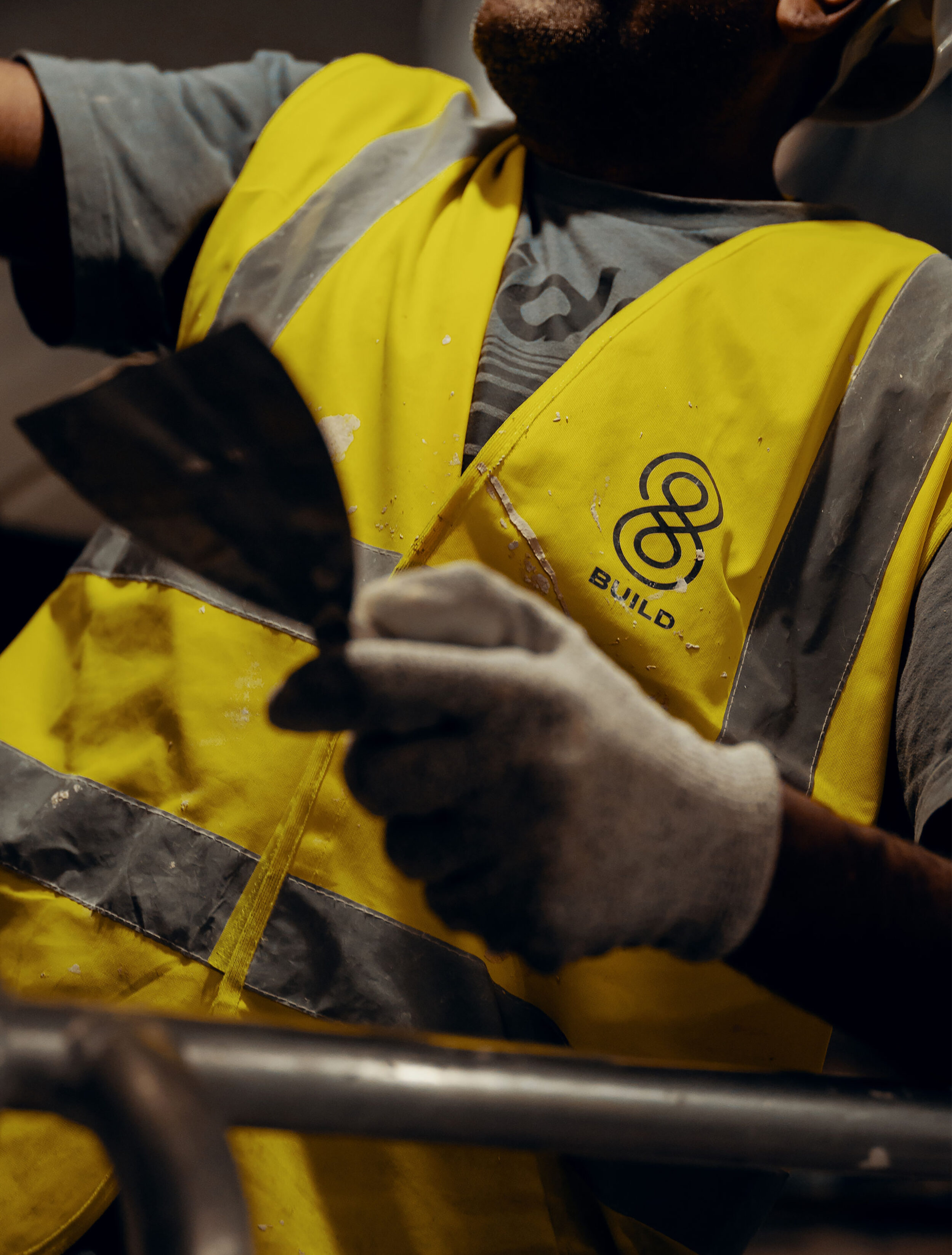 A male construction worker with a 8build branded t-shirt