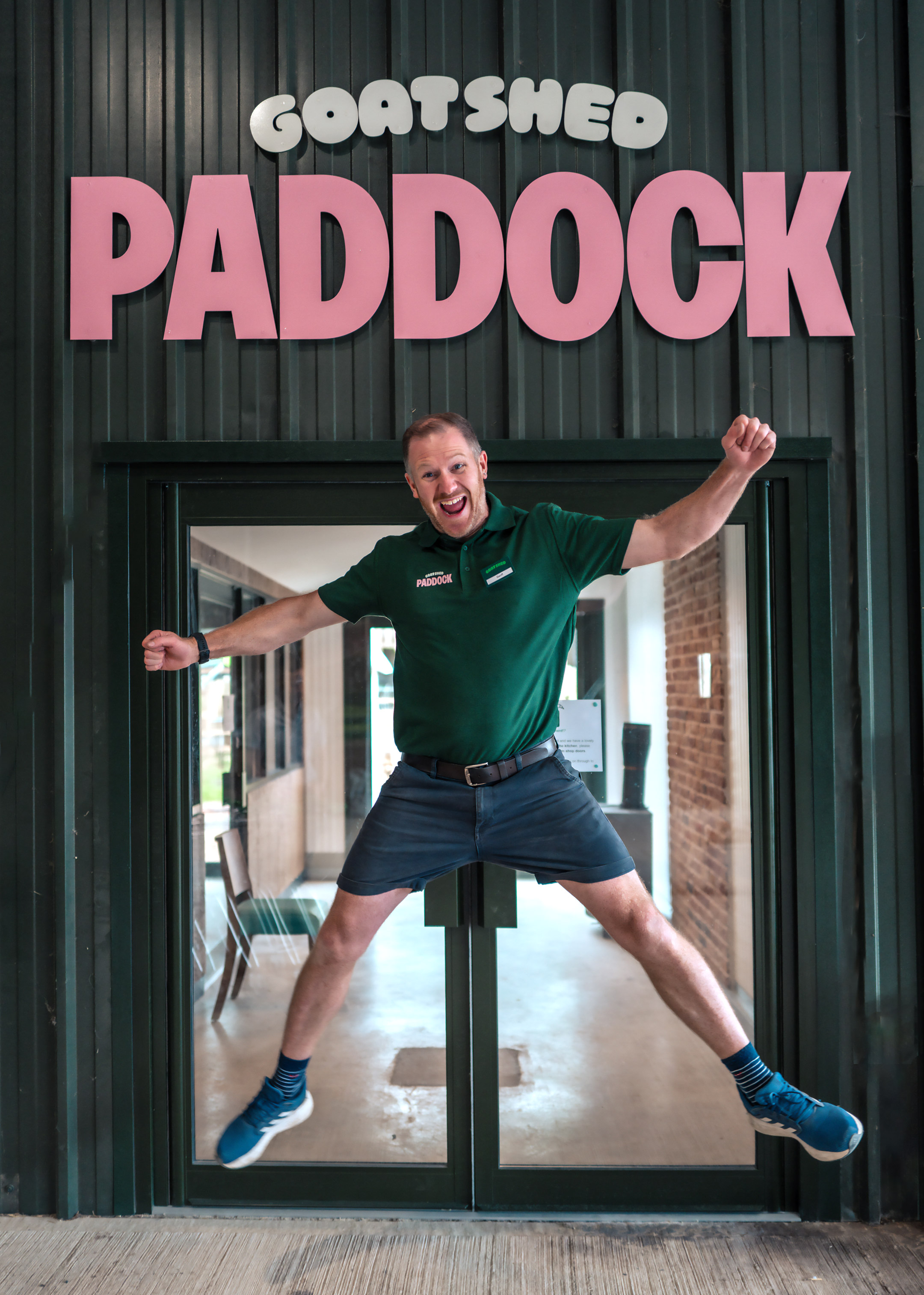 Goat shed employee jumping outside of shop