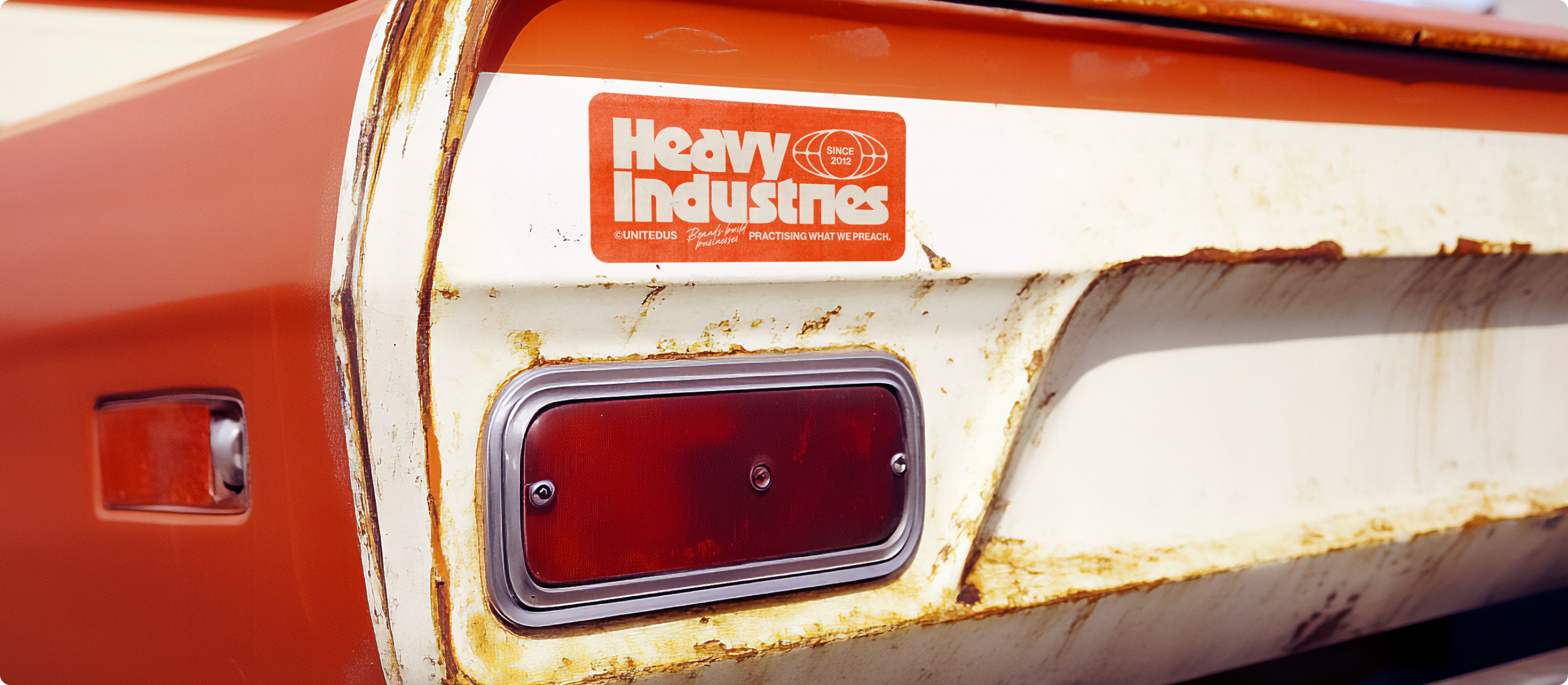Heavy Industries bumper - a rusty old American style car with a Heavy Industries bumper sticker