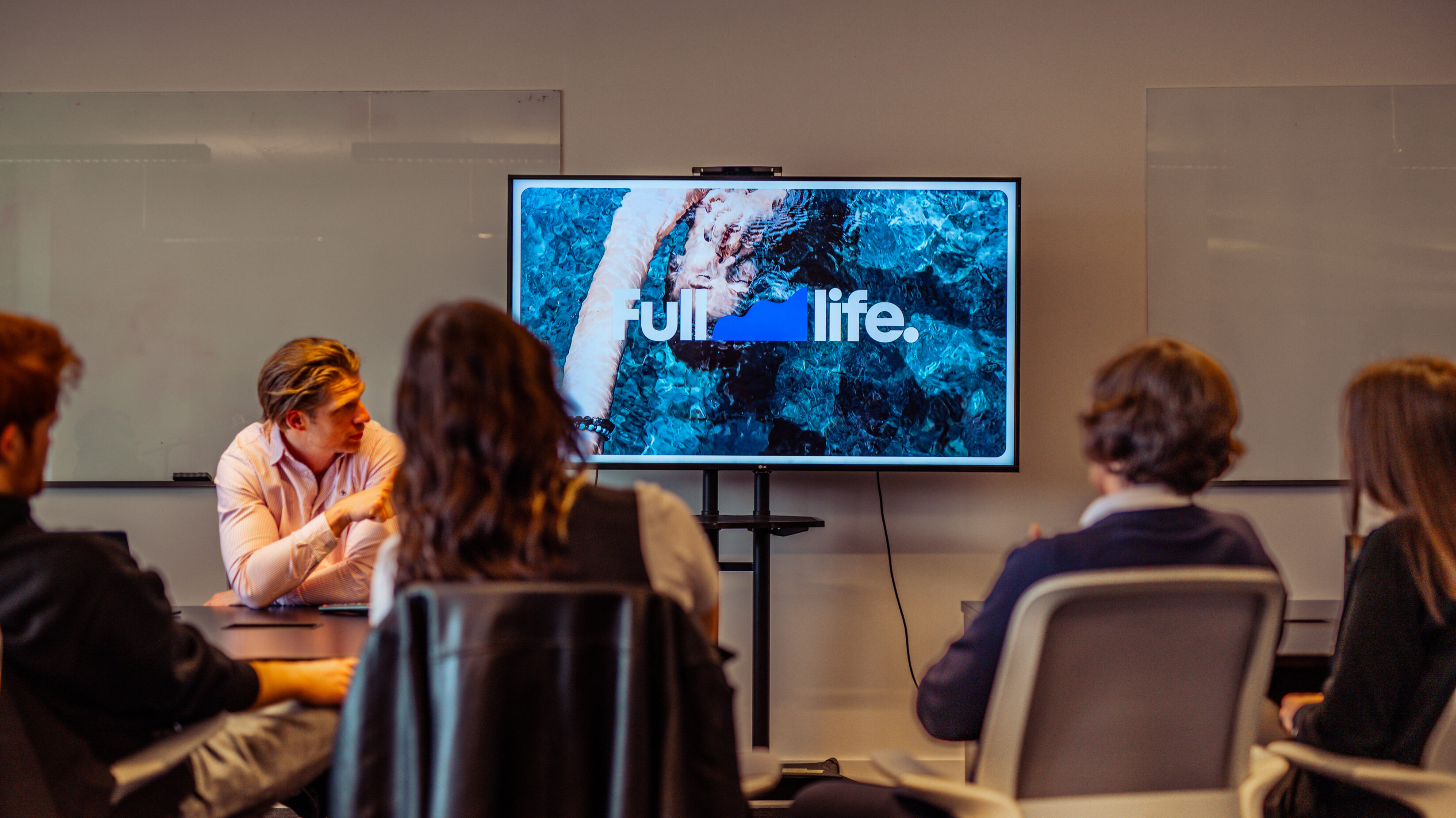 Spectrum board meeting with spectrum brand on screen