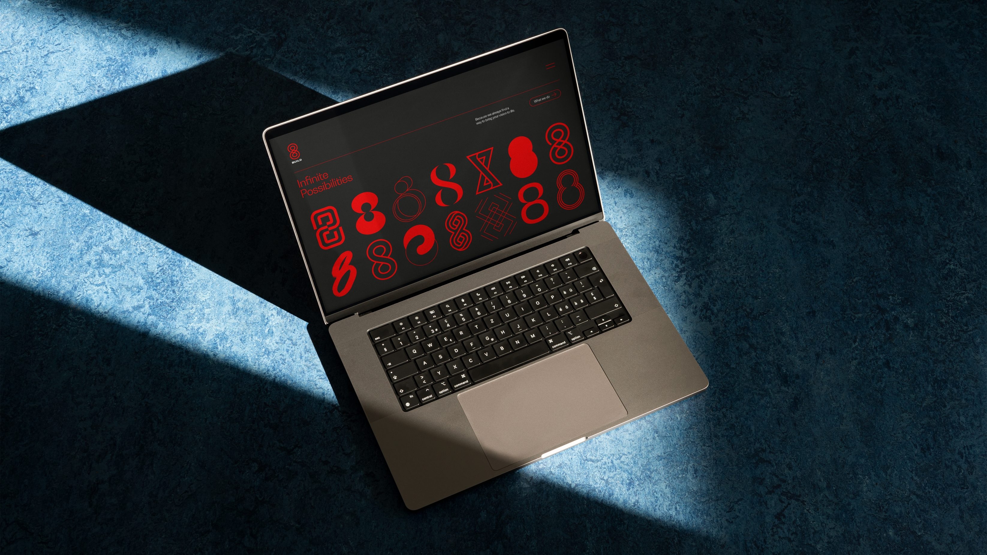 Website hero, containing a grid on infinite 8's, visualised on a laptop