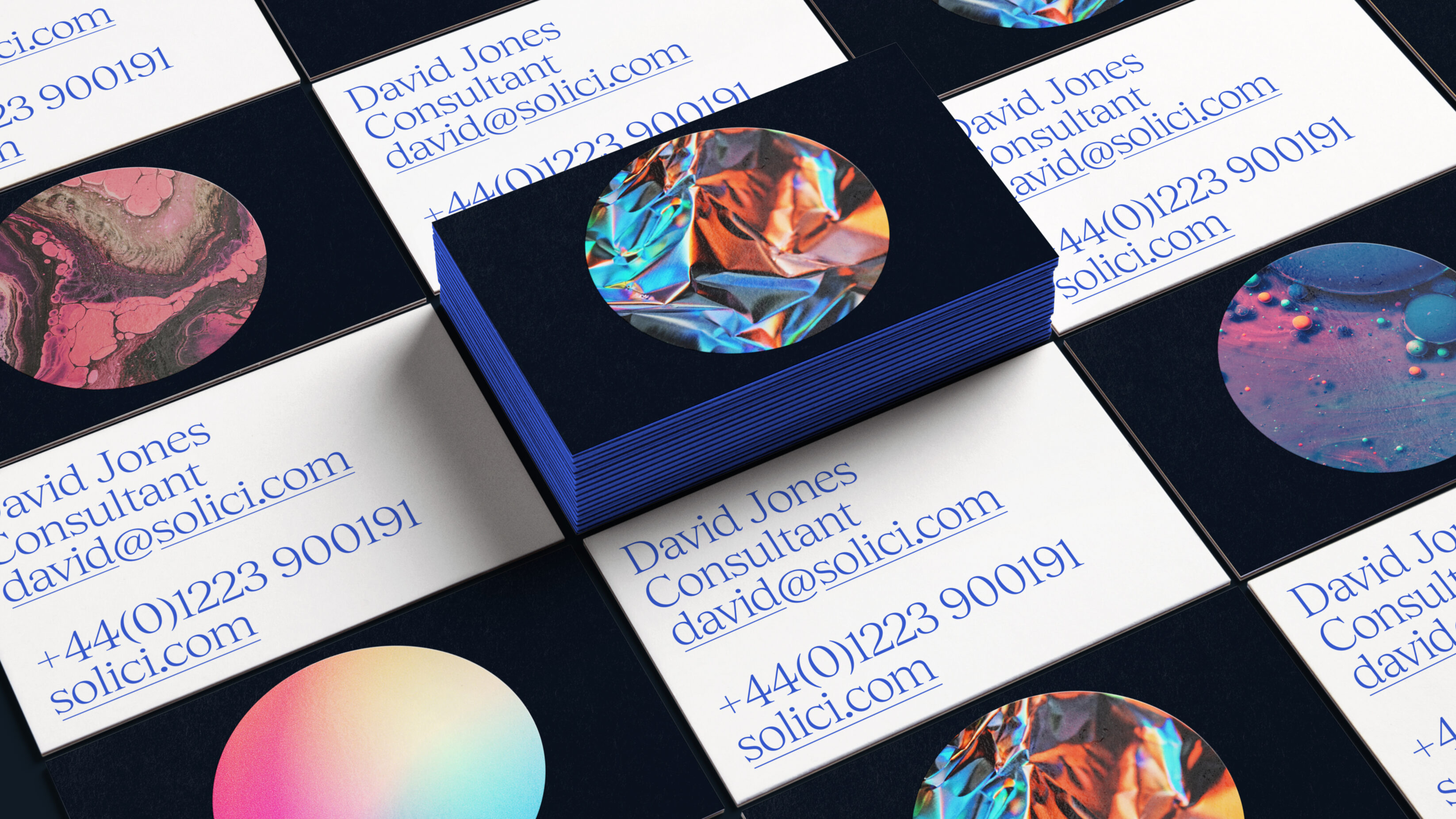 Branded business card designs. Simple blue text on white, the other side is a very dark blue with a large centred circle of various patterns each playing with the materials colours and texture.