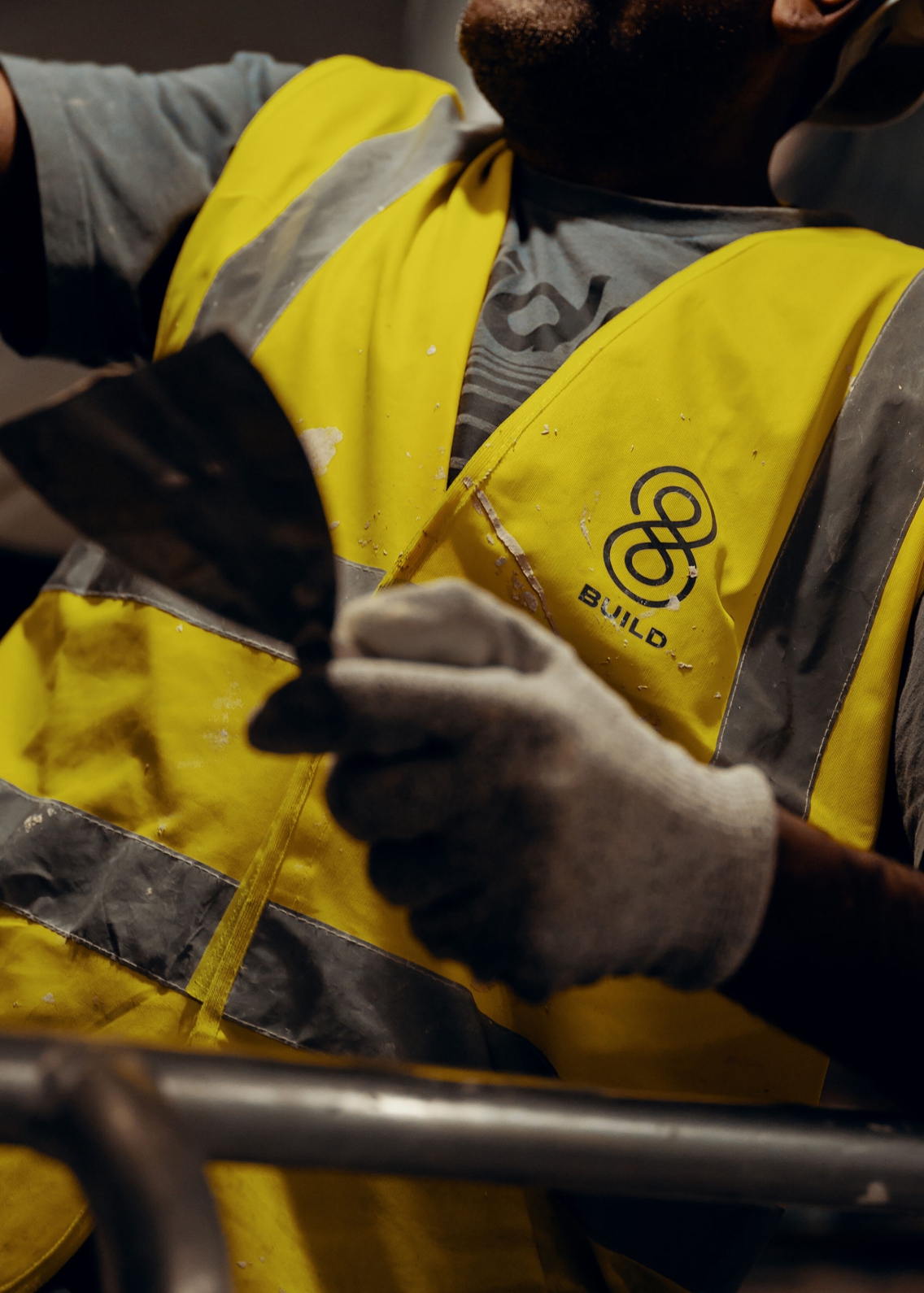 A male construction worker with a 8build branded t-shirt