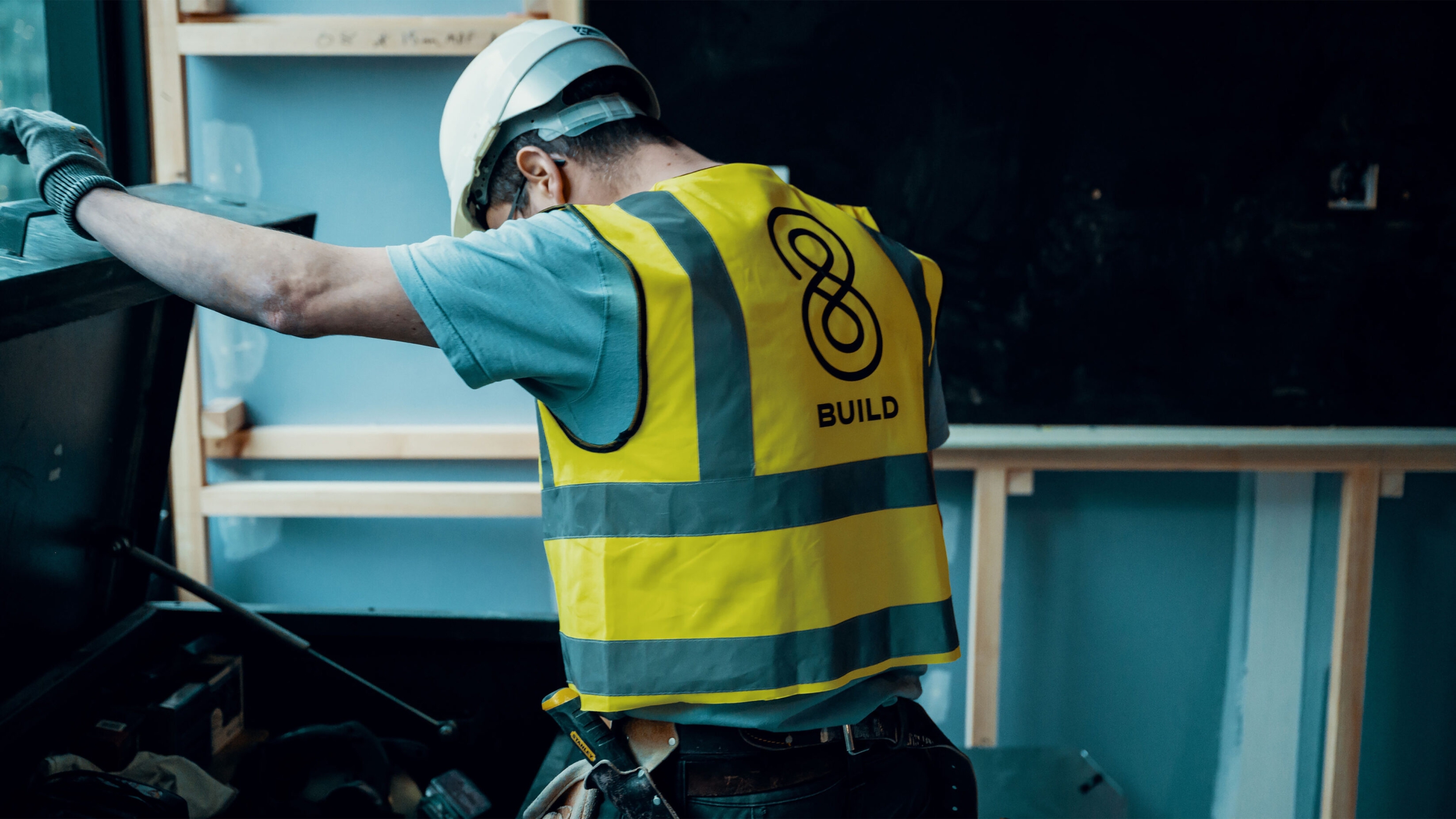 Workers on a construction site with branded hi-vis jackets on