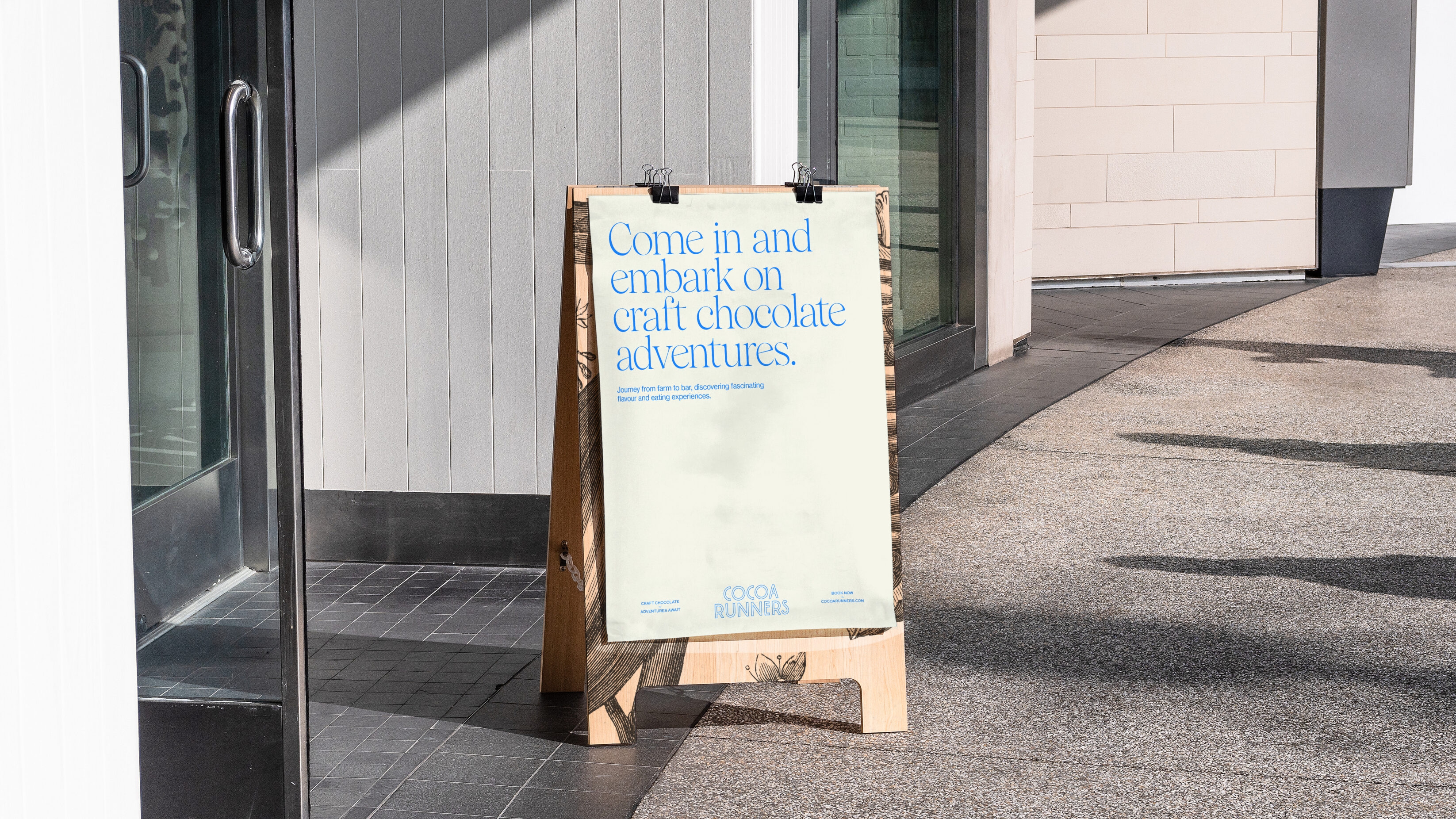 Wooden a-frame stand, with a type only poster on it to entice people into the shop.