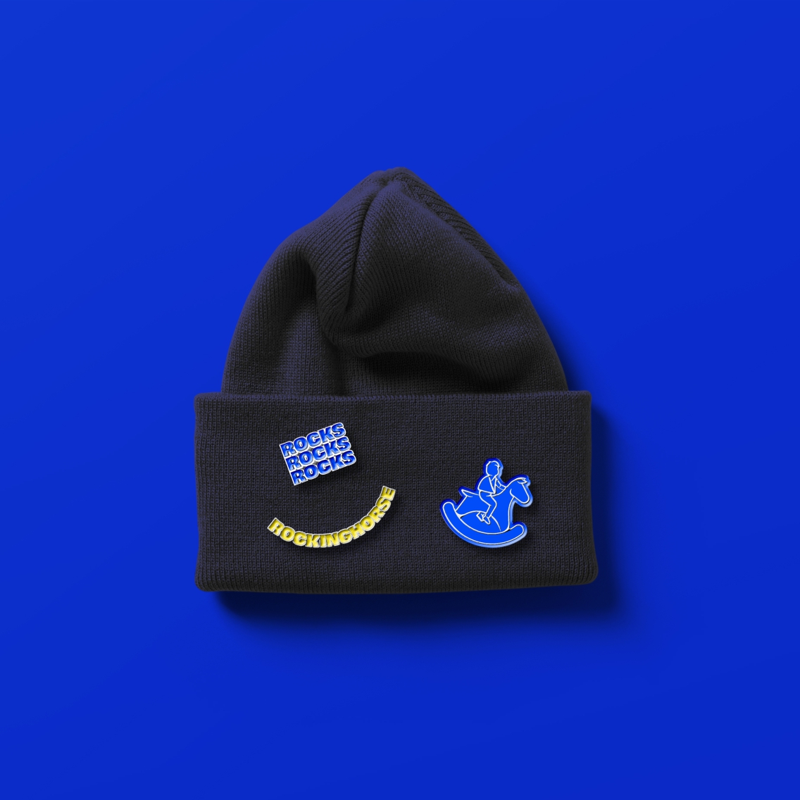 A beanie with some Rockinghorse badges on it