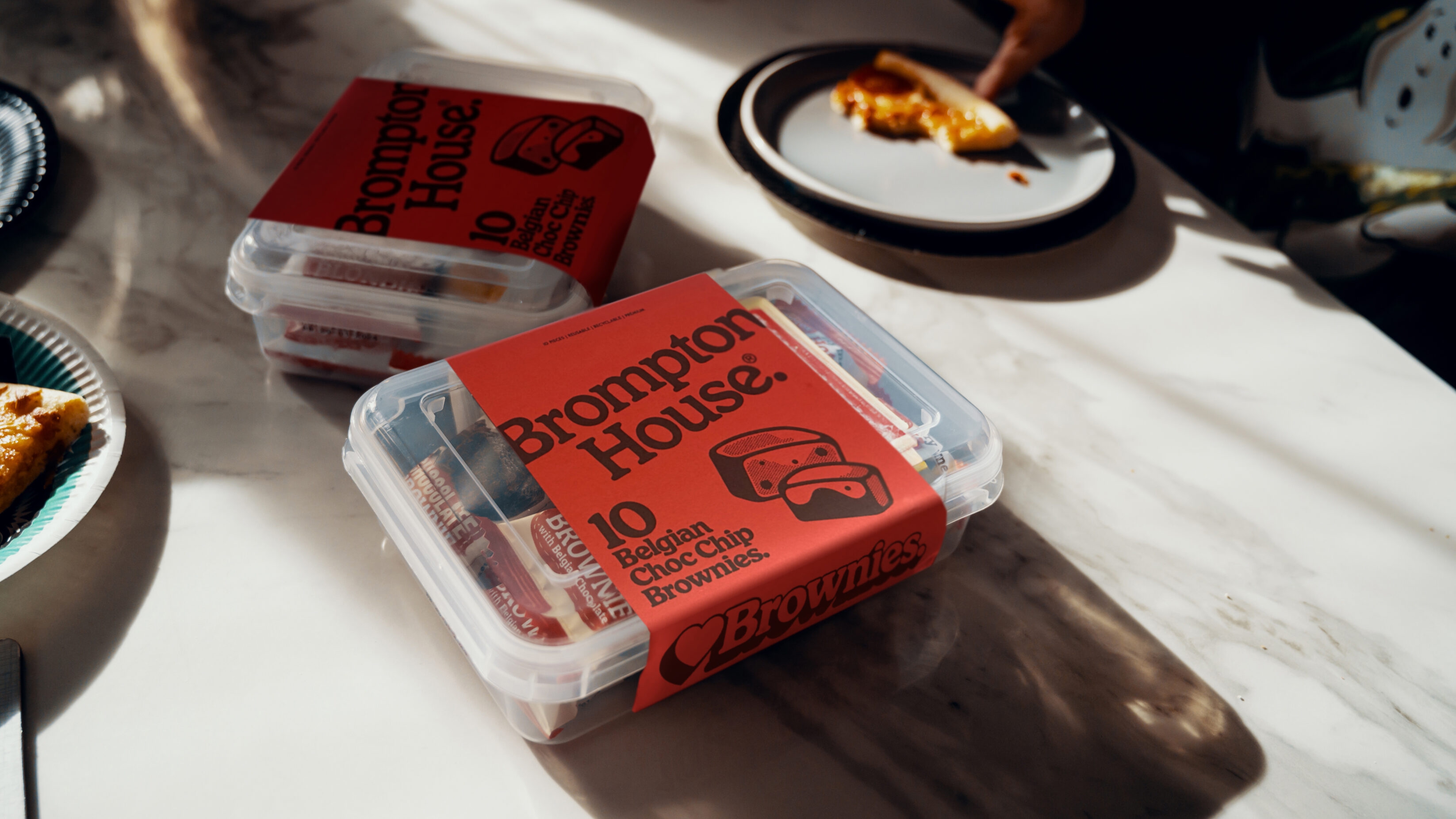Boxed Brompton House Belgian Chocolate Chip Brownies on a dining room table.