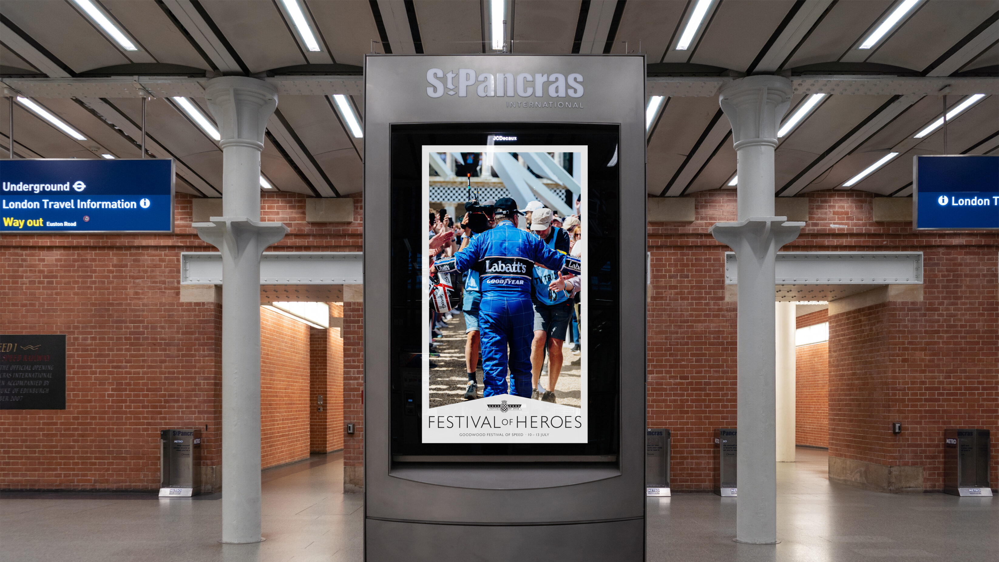 Digital billboard at St Pancras station, showing an poster promoting the Festival of Heroes theme.