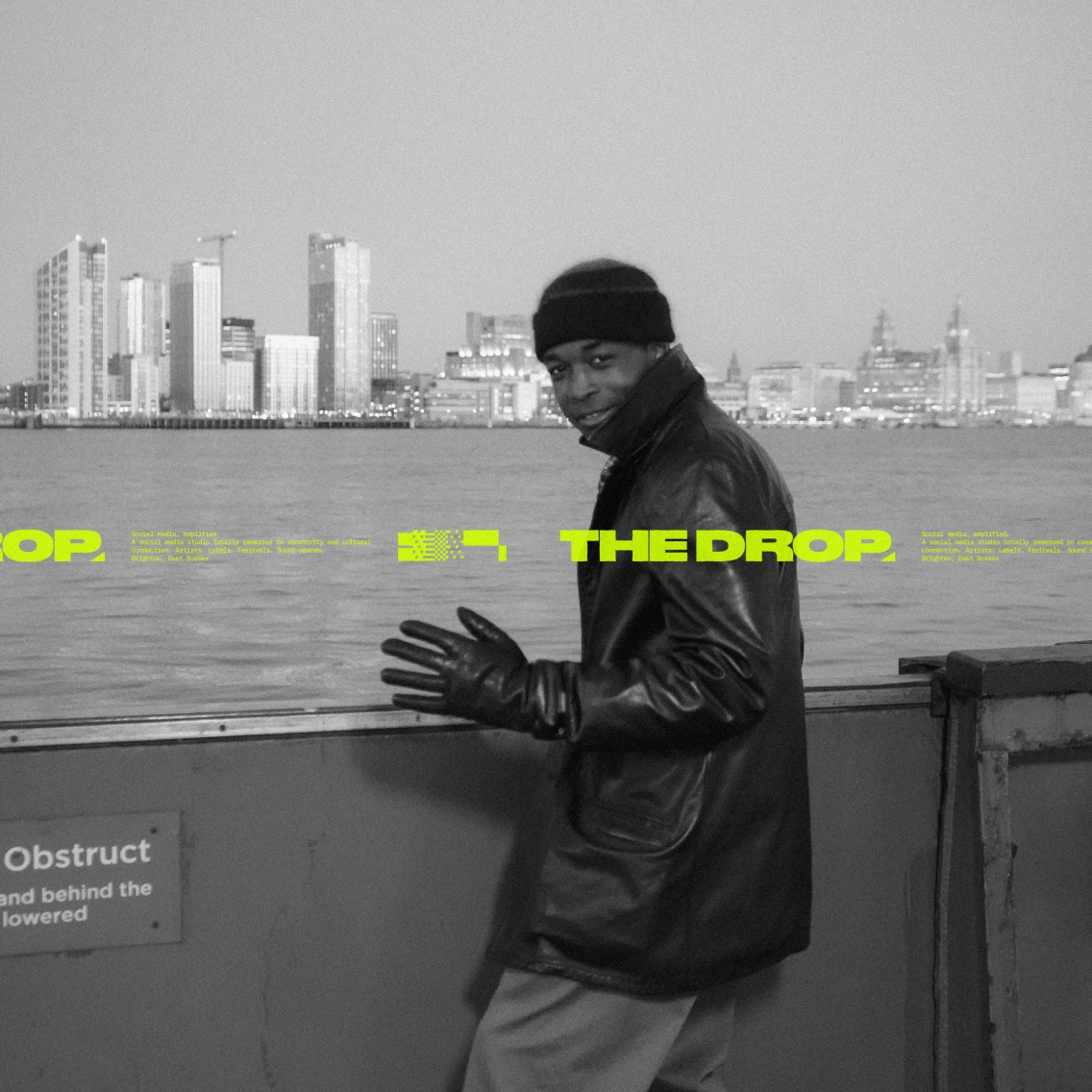 Ticket tape overlaid onto a black and white image of a black man standing on the edge of a river