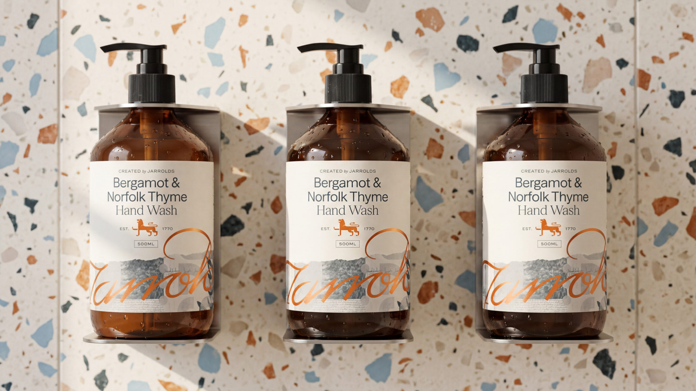 Three bottles of handwash in a premium bathroom environment.