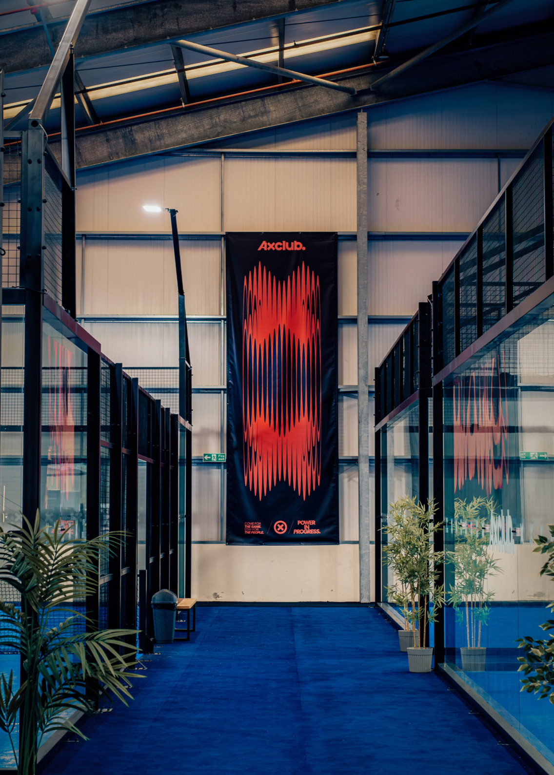 Interior photograph of a large format banner hanging from the wall, with stylised X's on it.