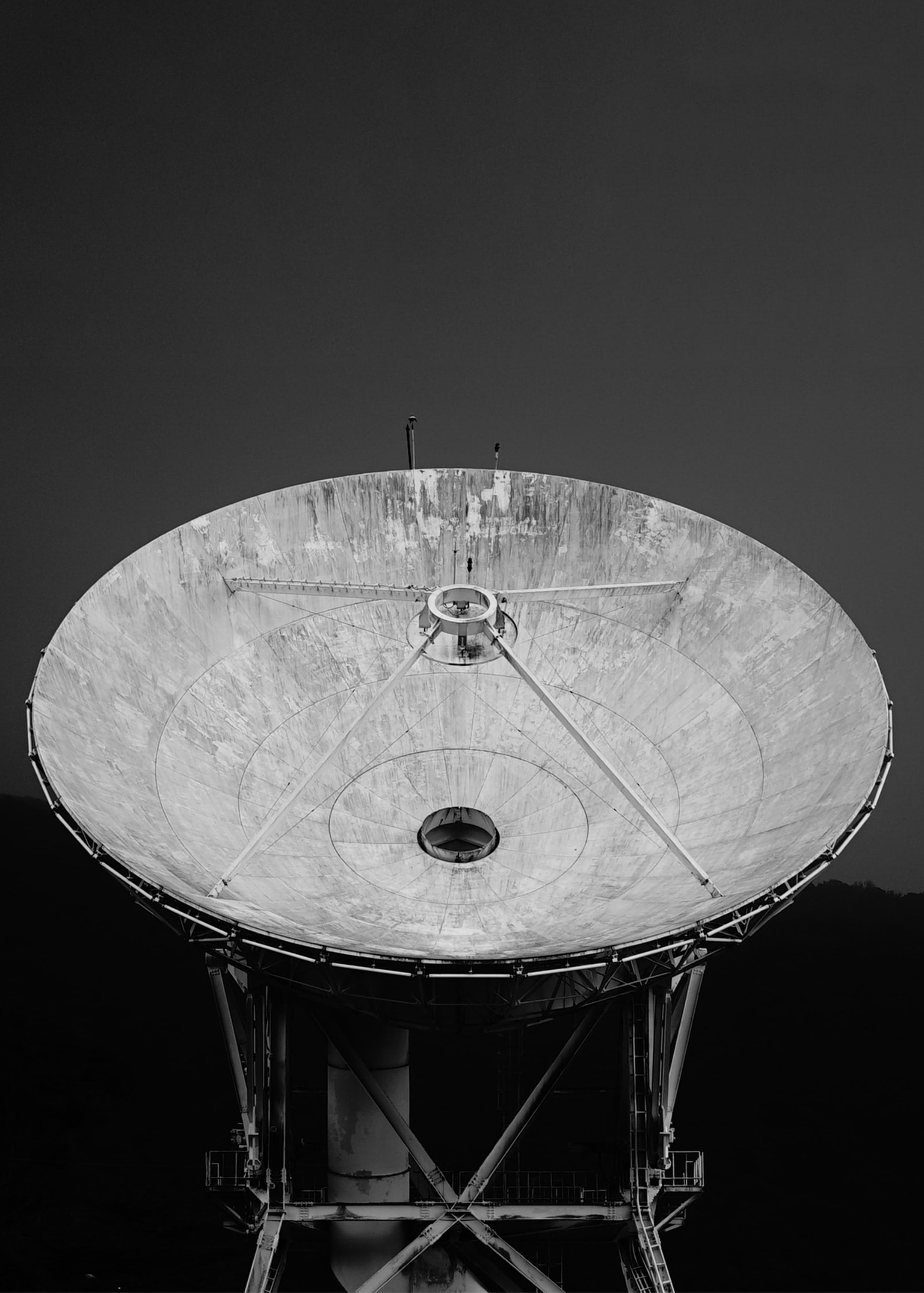 A black and white portrait close-up of a satellite dish